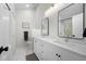 Bright bathroom with double sink vanity, large mirrors, and modern fixtures at 23551 Genesee Village Rd # H, Golden, CO 80401