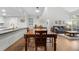 Spacious dining area with wood table, seating, and serving bar at 23551 Genesee Village Rd # H, Golden, CO 80401