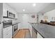 Bright kitchen with granite countertops, stainless appliances and modern cabinets at 23551 Genesee Village Rd # H, Golden, CO 80401