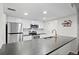 Modern kitchen features stainless steel appliances, white cabinets, and stone countertops at 23551 Genesee Village Rd # H, Golden, CO 80401