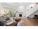 Open living room with a fireplace, sofa, and balcony access at 23551 Genesee Village Rd # H, Golden, CO 80401