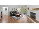 Cozy living room with a fireplace, balcony access, and natural light at 23551 Genesee Village Rd # H, Golden, CO 80401