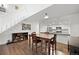 Open floor plan with dining table, stairs, and access to the kitchen at 23551 Genesee Village Rd # H, Golden, CO 80401