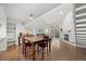 Open-concept living room featuring hardwood floors, a fireplace, and a dining table with seating at 23551 Genesee Village Rd # H, Golden, CO 80401