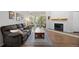 Comfortable living room featuring a fireplace, sofa, and sliding glass doors to a balcony at 23551 Genesee Village Rd # H, Golden, CO 80401