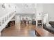 Bright open-concept living room with wood floors, staircase, and direct access to the kitchen and dining area at 23551 Genesee Village Rd # H, Golden, CO 80401