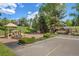 Outdoor playground offering a fun and safe space for children to play with community buildings in background at 23551 Genesee Village Rd # H, Golden, CO 80401