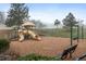 Community playground offering a fun playset with slides, swings, and seating under a light fog at 23551 Genesee Village Rd # H, Golden, CO 80401