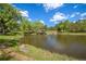 Scenic pond view with surrounding greenery and a charming gazebo, perfect for relaxation at 23551 Genesee Village Rd # H, Golden, CO 80401