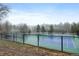 Community tennis courts featuring well-maintained blue and green surface, surrounded by a secure black fence at 23551 Genesee Village Rd # H, Golden, CO 80401