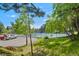Tennis courts surrounded by lush trees, offering a scenic and active recreational area for residents at 23551 Genesee Village Rd # H, Golden, CO 80401
