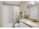 Bright bathroom featuring granite counters, decorative towels, and a shower with decorative curtain at 3529 S Telluride Cir # D, Aurora, CO 80013