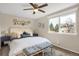 Bright bedroom with a ceiling fan, a comfortable bed, and a large window at 3529 S Telluride Cir # D, Aurora, CO 80013