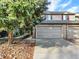 Charming townhome features an attached two-car garage, brick accents, and mature trees at 3529 S Telluride Cir # D, Aurora, CO 80013