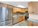 Modern kitchen with stainless steel appliances, granite countertops, and wood cabinets at 3529 S Telluride Cir # D, Aurora, CO 80013