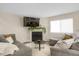 Cozy living room featuring a fireplace, large window, and comfortable gray sectional sofa at 3529 S Telluride Cir # D, Aurora, CO 80013