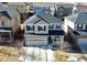 Aerial view of a well maintained two-story home with neutral siding and a stone facade in a Gathering neighborhood at 25206 E Lake Dr, Aurora, CO 80016