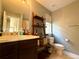 Cozy bathroom with single sink vanity and decorative shelving at 25206 E Lake Dr, Aurora, CO 80016