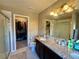 Bathroom featuring double sink vanity with granite counters and a walk-in closet at 25206 E Lake Dr, Aurora, CO 80016