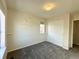 This bedroom features neutral walls and carpet, a window and closet, and floating shelves at 25206 E Lake Dr, Aurora, CO 80016