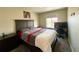 Bedroom features a dark wood bed frame, desk, and carpeted floors at 25206 E Lake Dr, Aurora, CO 80016