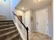 Inviting entryway with a tiled floor, staircase and white front door at 25206 E Lake Dr, Aurora, CO 80016