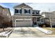 Inviting two-story home showcasing a stone facade, neutral siding, a two car garage and a well-maintained driveway at 25206 E Lake Dr, Aurora, CO 80016