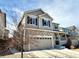 Charming two-story home featuring a stone facade, neutral siding, and a well-manicured front yard at 25206 E Lake Dr, Aurora, CO 80016