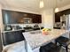 Modern kitchen boasts granite countertops, stainless steel appliances, and ample dark wood cabinetry at 25206 E Lake Dr, Aurora, CO 80016