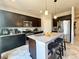 Spacious kitchen includes a granite island with seating, modern appliances, and pendant lighting at 25206 E Lake Dr, Aurora, CO 80016