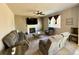 Cozy living room features comfortable seating, a fireplace, and a ceiling fan at 25206 E Lake Dr, Aurora, CO 80016