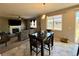 Inviting dining area flows into a comfortable living room with a fireplace and neutral decor at 25206 E Lake Dr, Aurora, CO 80016