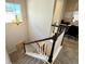 Carpeted staircase with white railings and a dark wood banister leading upstairs at 25206 E Lake Dr, Aurora, CO 80016