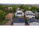 Aerial view of modern homes with solar panels surrounded by lush greenery and mountain views at 2248 S Lincoln St, Denver, CO 80210