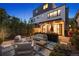 Inviting backyard patio with modern outdoor seating and landscaped planters under ambient lighting at 2248 S Lincoln St, Denver, CO 80210