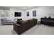 Large basement features a gray chaise, entertainment center, TV, piano, and brown sofa at 2248 S Lincoln St, Denver, CO 80210