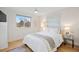 Cozy bedroom with hardwood floors, a ceiling fan, a plush bed, and calming natural light at 2248 S Lincoln St, Denver, CO 80210