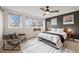 Bright bedroom with a ceiling fan, modern windows, and a comfortable chair by a side table at 2248 S Lincoln St, Denver, CO 80210