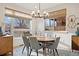 Bright dining room features a round table, elegant chandelier, and large windows with natural light at 2248 S Lincoln St, Denver, CO 80210