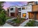 Modern home showcasing clean lines, mixed materials, and a well-manicured front yard with vibrant landscaping at 2248 S Lincoln St, Denver, CO 80210