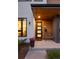 Modern home entrance with wood accents, stylish lighting, and a cozy bench at 2248 S Lincoln St, Denver, CO 80210