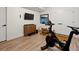 Home gym featuring wood flooring, a television, and exercise equipment at 2248 S Lincoln St, Denver, CO 80210