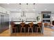 Stylish kitchen featuring a large island with seating, stainless steel appliances, and modern cabinetry at 2248 S Lincoln St, Denver, CO 80210