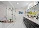 Modern main bathroom with dual vanities, a luxurious soaking tub, and glass-enclosed shower at 2248 S Lincoln St, Denver, CO 80210