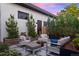 Stylish outdoor patio with comfortable seating, lush landscaping, and tranquil water feature at 2248 S Lincoln St, Denver, CO 80210