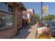Charming brick building facade with a small patio and tree-lined street view at 2248 S Lincoln St, Denver, CO 80210