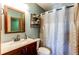 Bathroom featuring vanity, sink, toilet, and shower with curtain at 9565 W Coal Mine Ave # A, Littleton, CO 80123