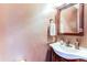Traditional half bathroom with decorative vanity, sink, and fixtures at 9565 W Coal Mine Ave # A, Littleton, CO 80123