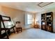 Bedroom with natural light, neutral colors, decorative chair and accent furniture at 9565 W Coal Mine Ave # A, Littleton, CO 80123