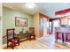 Charming dining area with a table, chairs, artwork, and seamless access to the kitchen and living area at 9565 W Coal Mine Ave # A, Littleton, CO 80123
